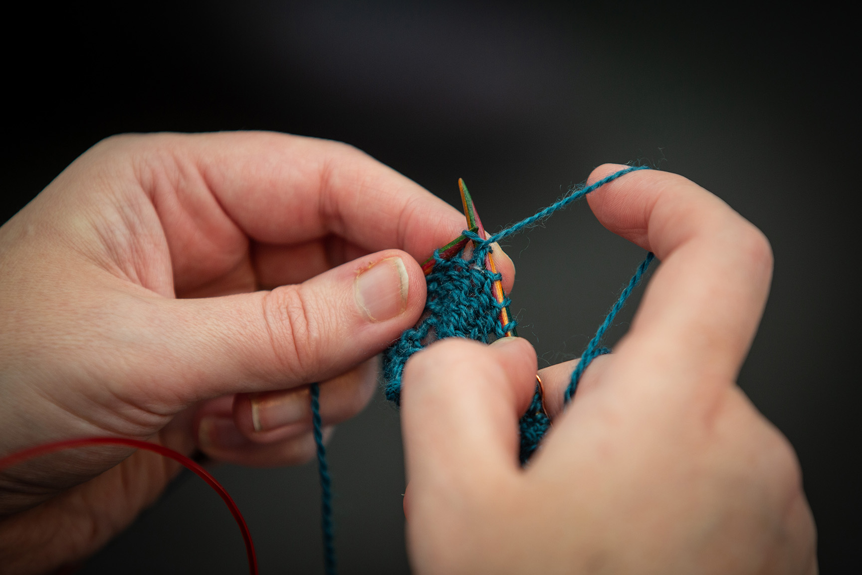 close up hands knitting